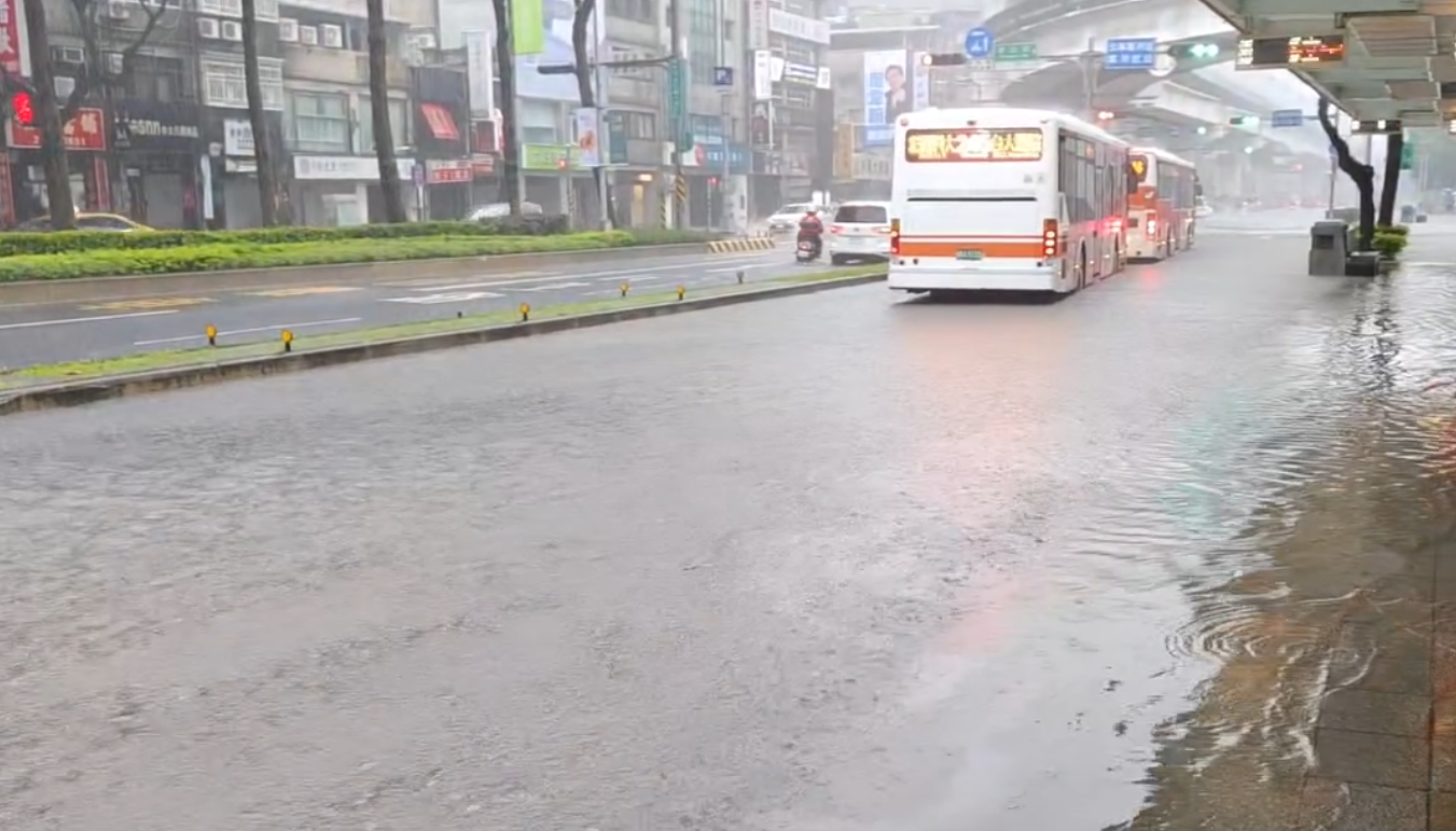 板橋火車站前公車站出現積水,雨水漫過馬路湧向公車月台。(網友授權Threads@ w.yaozhou)