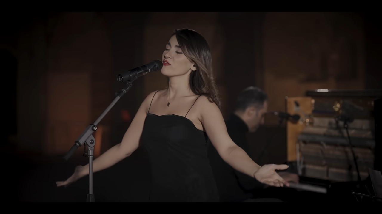 伊朗女歌手阿赫馬迪僅因在直播中未配戴頭巾高唱愛國歌曲,竟遭法院判處74下鞭刑及2年禁演令。(翻攝自YouTube頻道@ParastooAhmadii)
